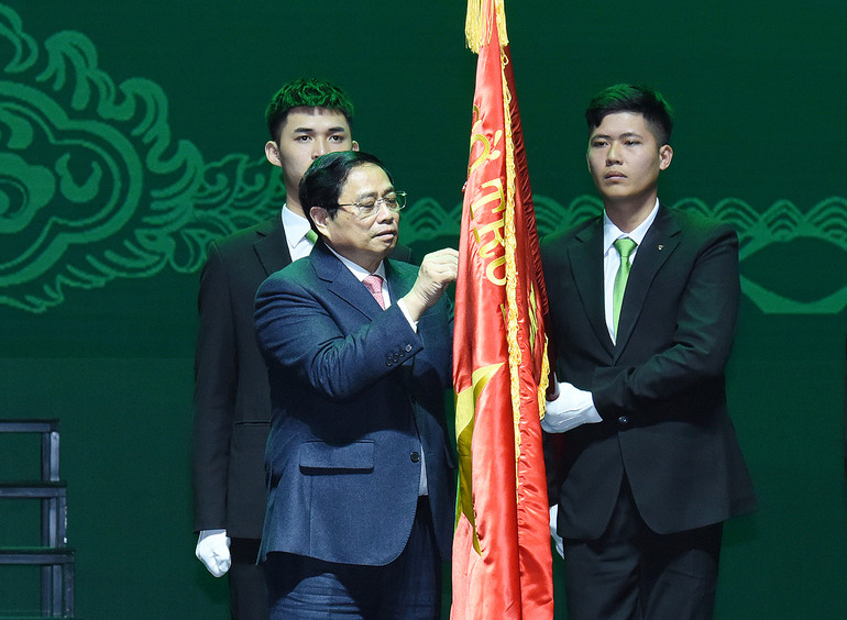 Thủ tướng Phạm Minh Chính gắn Danh hiệu Anh hùng Lao động lên cờ truyền thống Vietcombank.