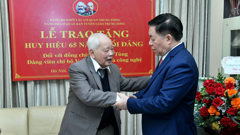 Đồng chí Nguyễn Trọng Nghĩa chúc sức khỏe đồng chí Lê Xuân Tùng. (Ảnh: ĐĂNG KHOA)