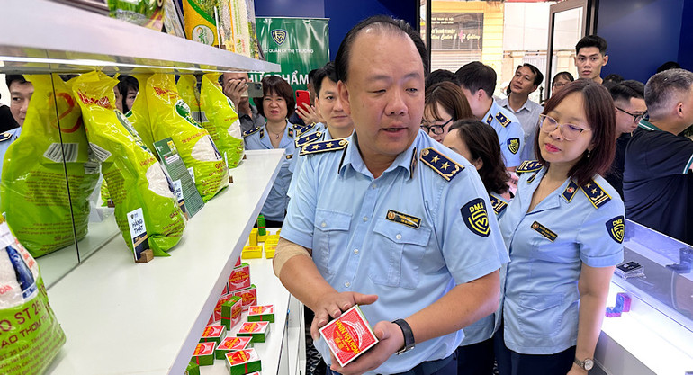 Tổng cục trưởng Quản lý thị trường Trần Hữu Linh hướng dẫn cách phân biệt bánh cốm Nguyên Ninh thật-giả.