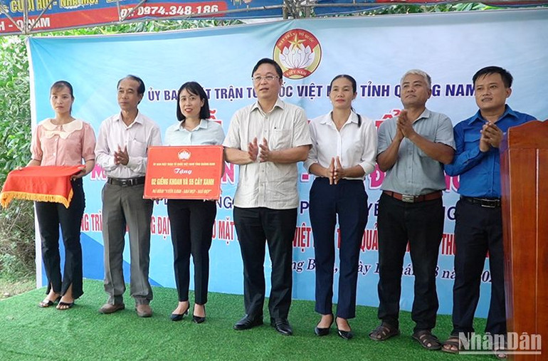 Chủ tịch Ủy ban Mặt trận Tổ quốc Việt Nam tỉnh Quảng Nam Lê Trí Thanh (đứng giữa) trao biểu trưng hỗ trợ 2 giếng khoan và 55 cây xanh cho thôn Linh Cang.