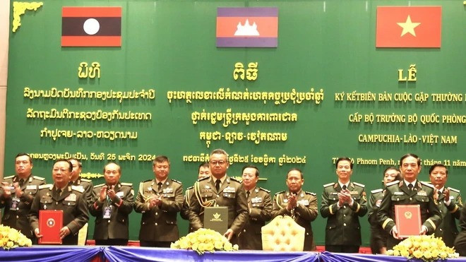Bộ trưởng Quốc phòng Campuchia-Lào-Việt Nam ký kết, trao đổi Biên bản Cuộc gặp thường niên Bộ trưởng Quốc phòng 3 nước. (Ảnh: Hoàng Minh/TTXVN)
