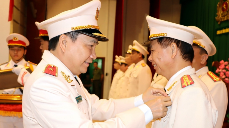 Thiếu tướng Nguyễn Sĩ Quang, Giám đốc Công an tỉnh Đồng Nai gắn Huân chương Chiến công hạng Ba của Chủ tịch nước tặng Đại tá Trần Tiến Đạt, Phó Giám đốc Công an tỉnh.