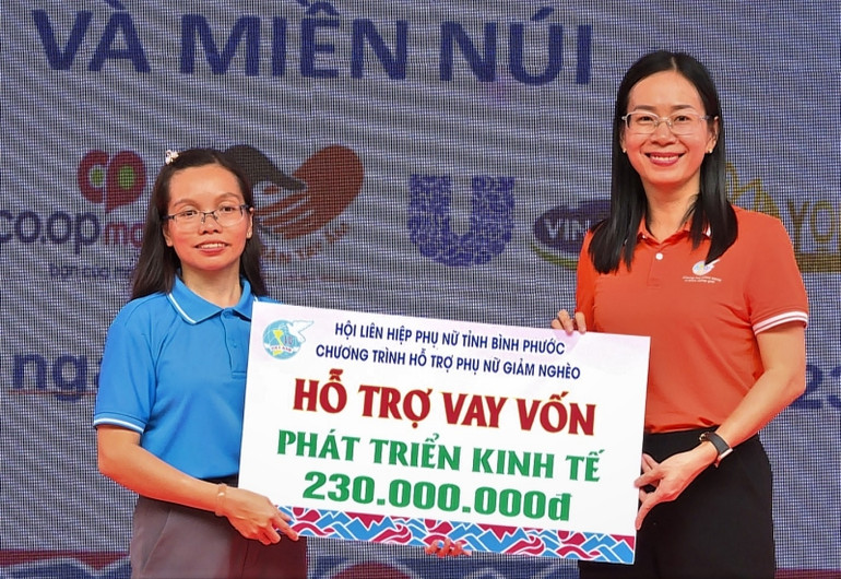 Chủ tịch Hội Liên hiệp Phụ nữ tỉnh Bình Phước trao vốn hỗ trợ phát triển kinh tế cho đại diện xã Lộc Phú, huyện Lộc Ninh).