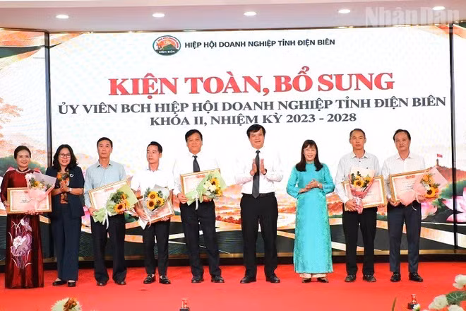 Đồng chí Lò Văn Cương, Phó Chủ tịch Ủy ban nhân dân tỉnh Điện Biên và các đồng chí lãnh đạo Hội đồng nhân dân tỉnh, Ủy ban Mặt trận Tổ quốc Việt Nam tỉnh tặng hoa, chúc mừng tập thể, cá nhân Hiệp hội Doanh nghiệp tỉnh Điện Biên được Liên đoàn Công nghiệp và Thương mại Việt Nam tặng Bằng khen. (Ảnh: LÊ LAN)