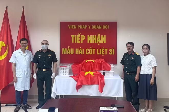 Đại diện Ban Chỉ đạo tìm kiếm, xác định danh tính liệt sĩ tỉnh Điện Biên bàn giao mẫu hài cốt liệt sĩ cho Viện Pháp y Quân đội. (Ảnh: ĐỨC HẠNH)