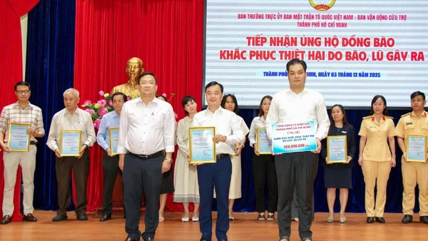 Đồng chí Trần Vũ Quang (đứng giữa), Ủy viên Ban Thường vụ, Chủ nhiệm Ủy ban Kiểm tra Đảng ủy EVNHCMC thay mặt tập thể cán bộ, công nhân viên Tổng công ty trao số tiền 300 triệu đồng đến Ủy ban Mặt trận Tổ quốc Việt Nam Thành phố Hồ Chí Minh.