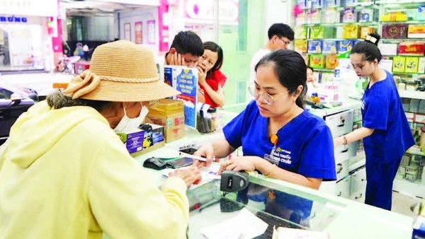 Người dân mua thuốc trên đường Hai Bà Trưng, phường Tân Định. (Ảnh THẾ ANH)