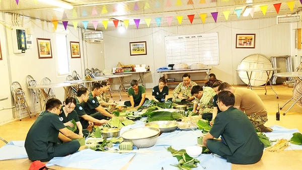 Những người lính Việt Nam tại Phái bộ gìn giữ hòa bình LHQ ở Nam Sudan gói bánh chưng đón Tết. Ảnh: TIẾN PHÚC