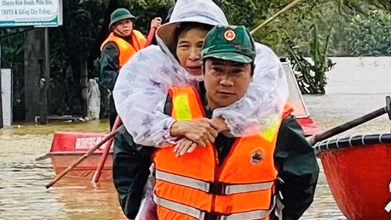 Lực lượng vũ trang dầm mình trong nước lũ giúp đỡ nhân dân.