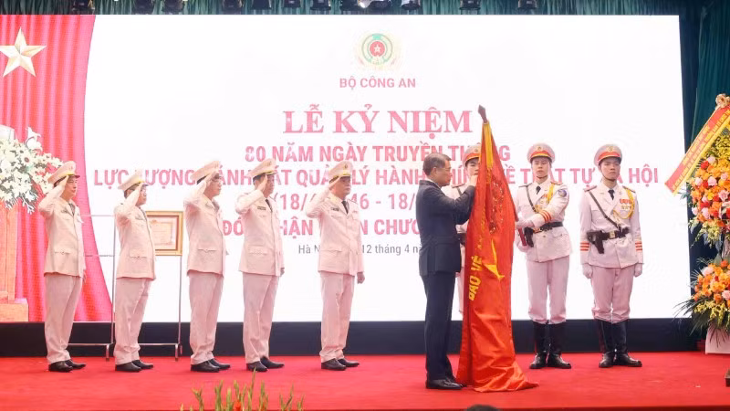 Thủ tướng Lê Minh Hưng gắn Huân chương Hồ Chí Minh lên Cờ truyền thống của lực lượng cảnh sát quản lý hành chính về trật tự xã hội.