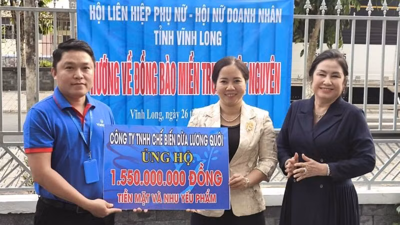 Công ty Trách nhiệm hữu hạn Chế biến dừa Lương Quới ủng hộ tiền mặt và nhu yếu phẩm trị giá hơn 1,5 tỷ đồng giúp đồng bào bị thiệt hại do mưa lũ. (Ảnh: HOÀNG TRUNG)