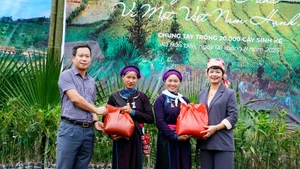 Đại diện Trung tâm Truyền thông Tài nguyên và Môi trường tặng quà cho người dân xã Bản Liền.
