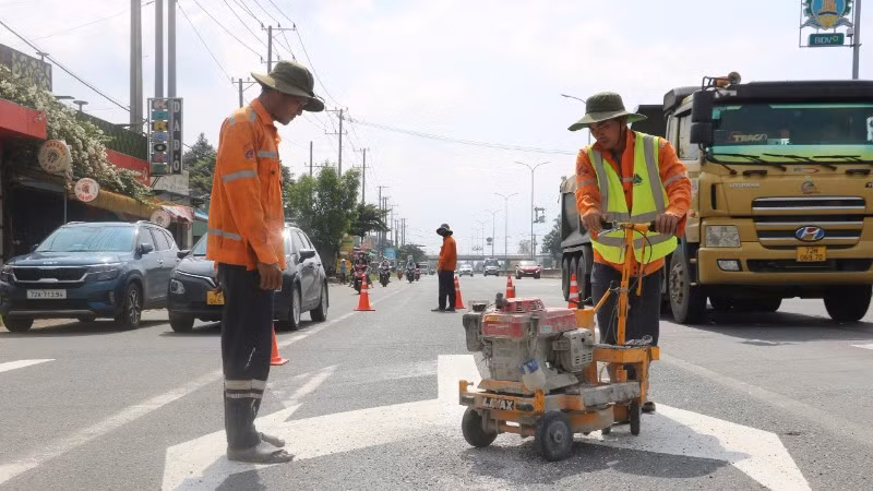 Công nhân sơn kẻ vạch đường trên Quốc lộ 51. 