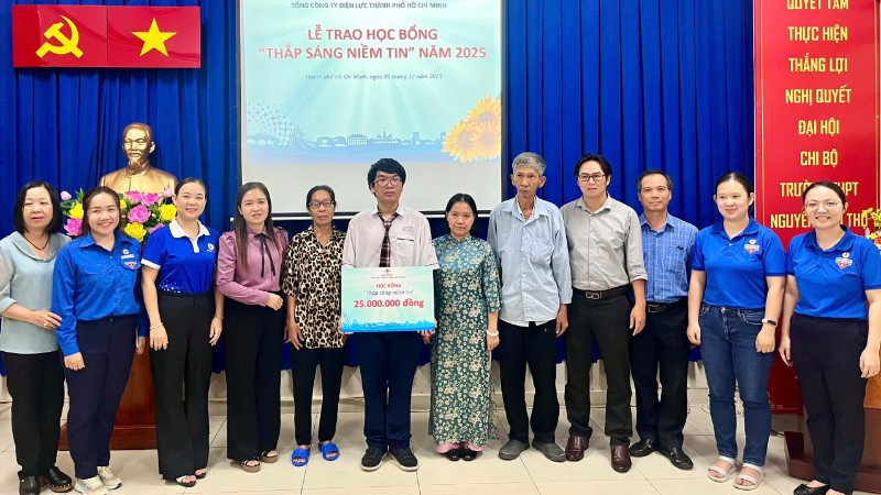 Đại diện EVNHCMC và các đơn vị trao học bổng "Thắp sáng niềm tin" đến em Nguyễn Đỗ Kim Long.