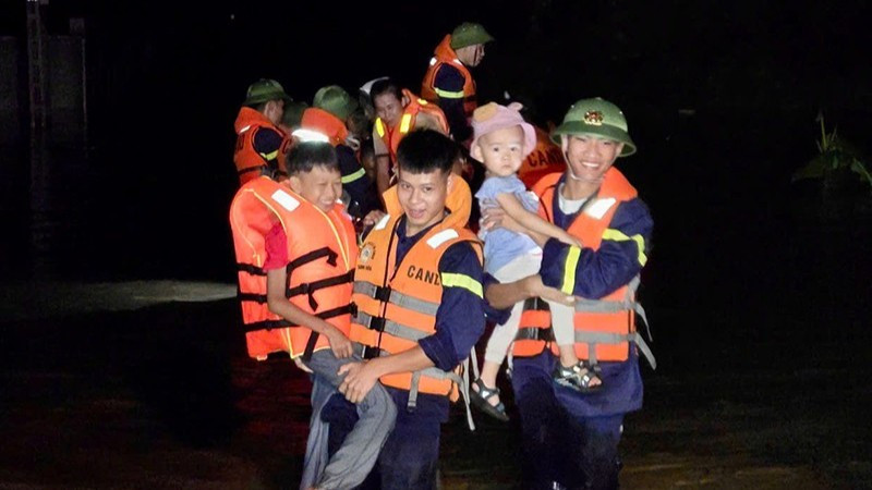Công an Thanh Hóa di chuyển trẻ em khỏi nơi ngập nước.