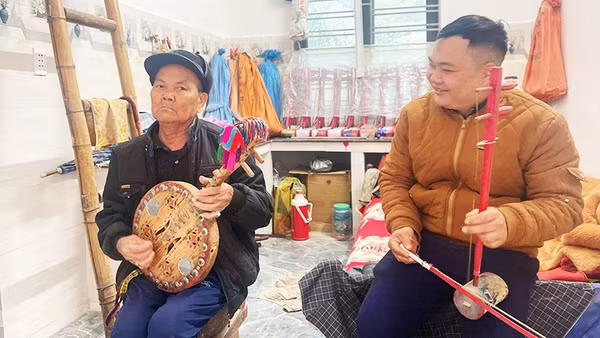 Nghệ nhân Váng Vần Séng (trái) chơi đàn lìn xìn.