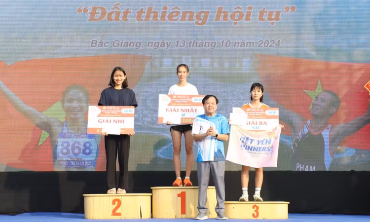 Đồng chí Trịnh Văn Ánh, Tổng Biên tập Báo Bắc Giang, Trưởng Ban tổ chức trao giải cho các VĐV nữ giành thành tích cao cự ly 5km.