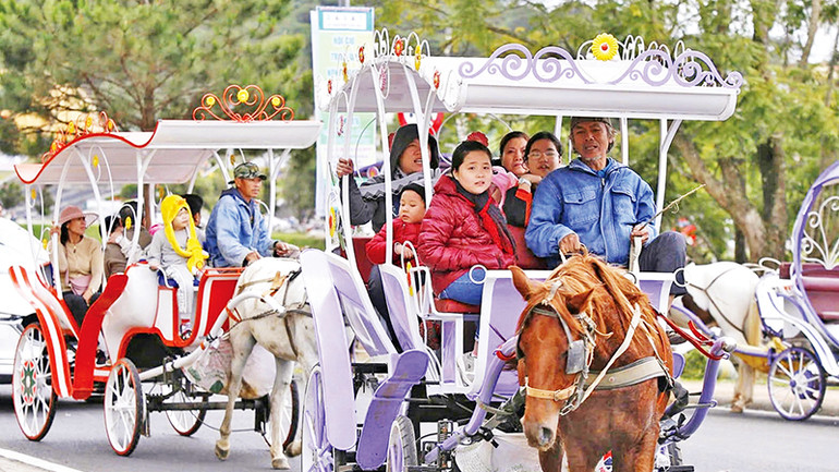 Du khách thích thú khi ngồi xe ngựa dạo quanh thắng cảnh cấp quốc gia hồ Xuân Hương.