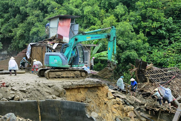 Huy động cao nhất máy móc, phương tiện tại chỗ giúp người dân xã Liên Minh khắc phục hậu quả thiên tai. (Ảnh: QUỐC HỒNG)
