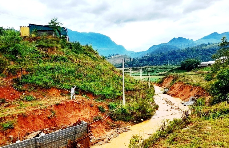 Khôi phục cột điện bị hư hại để cấp điện lưới trở lại cho vùng lũ ống và phục vụ công tác cứu hộ, cứu nạn tại đây. (Ảnh: VŨ TUẤN)