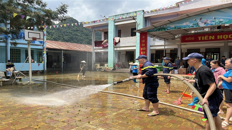 Cán bộ, chiến sĩ công an giúp trường học ở xã Quang Vinh, huyện Trùng Khánh khắc phục hậu quả mưa lũ. (Ảnh: Công an Cao Bằng)