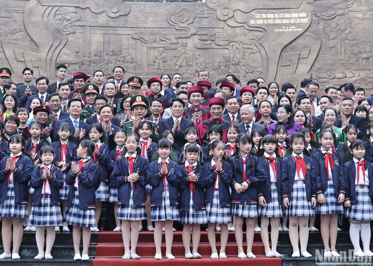 Chủ tịch nước cùng các đại biểu, các cháu thiếu nhi và nhân dân tại Bức phù điêu Bác Hồ nói chuyện với cán bộ, chiến sĩ Đại đoàn quân Tiên phong. (Ảnh:NGỌC LONG)