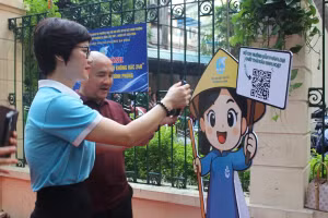 Cán bộ hướng dẫn người dân quét mã QR, phân loại chất thải rắn sinh hoạt. Nguồn: Hội Liên hiệp Phụ nữ phường Ba Đình