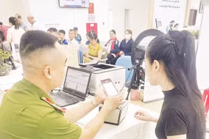 Cán bộ Phòng Cảnh sát QLHC về TTXH hướng dẫn người dân tích hợp tài khoản an sinh xã hội trên VNeID. 