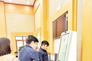 Người dân làm thủ tục hành chính qua Kiosk AI ở phường Bắc Giang. 