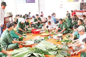 Lực lượng Bộ đội Biên phòng tỉnh Đồng Nai gói bánh chưng cùng nhân dân xã Lộc Thạnh, tỉnh Đồng Nai. 