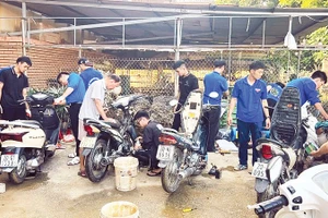 Sinh viên tình nguyện Trường đại học Điện lực sửa chữa xe máy cho người dân Thái Nguyên.
