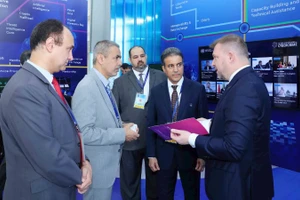 Đại biểu tham quan không gian trưng bày công nghệ của Liên hợp quốc tại Lễ mở ký Công ước Hà Nội. (Ảnh TTXVN)