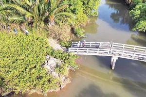 Cây cầu dân sinh được xây dựng ở khu vực Lộ Tẻ đã lâu nhưng không đường dẫn, không có móng kiên cố nằm giữa đồng không mông quạnh.