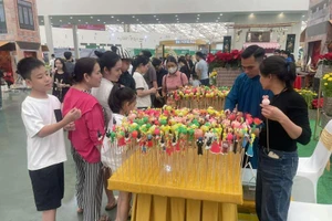 Trẻ em thích thú trải nghiệm gian hàng bán tò he tại Hội chợ Mùa Thu lần thứ nhất - 2025.