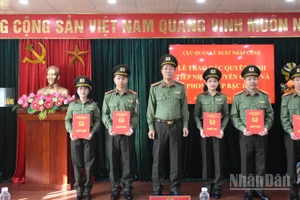 Thượng tá Hoàng Minh Thắng, Trưởng Công an cửa khẩu Cảng hàng không Quốc tế Đà Nẵng trao quyết định cho các đồng chí được phong cấp bậc hàm. (Ảnh: ANH ĐÀO)