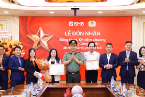 Đại tá Nguyễn Tiến Đạt, Phó Giám đốc Công an TP Hà Nội trao bằng khen và công nhận tới đại diện lãnh đạo SHB.