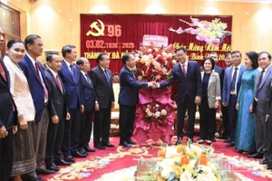 Đồng chí Daovong Phonekeo tặng lẵng hoa chúc mừng đồng chí Lê Ngọc Quang, Ủy viên Trung ương Đảng, Bí thư Thành ủy Đà Nẵng. (Ảnh: ANH ĐÀO)