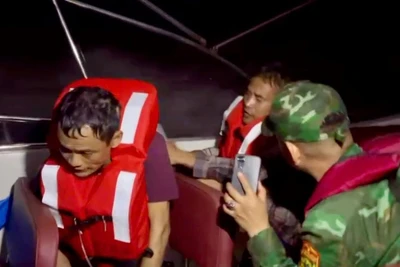 Cán bộ, chiến sĩ Đồn Biên phòng Cát Bà đưa thuyền viên bị nạn vào bờ.