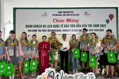 Lãnh đạo Sở Văn hóa, Thể thao và Du lịch tỉnh Bến tre tặng quà cho đoàn khách quốc tế đầu tiên đến Bến Tre năm 2025. (Ảnh: HOÀNG TRUNG)