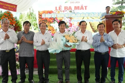 Lãnh đạo tỉnh Bến Tre tặng hoa chúc mừng trong buổi lễ ra mắt nhận diện thương hiệu Làng Văn hóa-Du lịch Chợ Lách. (Ảnh: HOÀNG TRUNG)