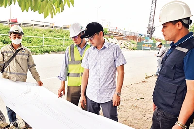 Ðại diện Ban Quản lý dự án và các đơn vị thi công tại công trường Dự án đường nối cao tốc Pháp Vân-Cầu Giẽ với đường vành đai 3. (Ảnh ÐĂNG ANH) 