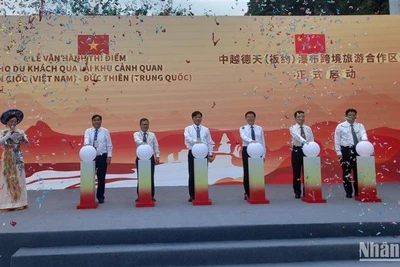 Các đại biểu thực hiện nghi thức vận hành thí điểm cho du khách qua lại tham quan thác Bản Giốc-Đức Thiên.