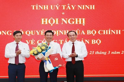 Đồng chí Nguyễn Văn Nên, Ủy viên Bộ Chính trị, Bí thư Thành ủy Thành phố Hồ Chí Minh (phải) và đồng chí Nguyễn Thành Tâm, Ủy viên Trung ương Đảng, Phó Trưởng ban Tổ chức Trung ương, trao quyết định, tặng hoa chúc mừng đồng chí Nguyễn Mạnh Hùng.