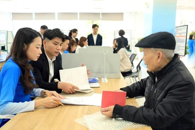 Hướng dẫn người dân làm dịch vụ công trực tuyến tại Trung tâm Phục vụ hành chính công thành phố Hà Nội , chi nhánh Tây Hồ. (Ảnh: MAI HỮU).