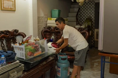 Người dân tại ngõ 661 Bạch Đằng dọn dẹp, kê cao đồ đạc lên cao đề phòng nước dâng cao.