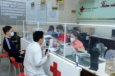 Bệnh nhân và người nhà làm thủ tục thanh toán bảo hiểm y tế tại Bệnh viện Ung bướu Hưng Việt (Hà Nội). (Ảnh NGUYỄN ĐĂNG) 