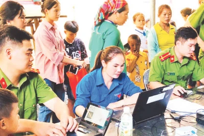 Đoàn viên, thanh niên hỗ trợ đăng ký trên Cổng dịch vụ công trực tuyến của Bộ Công an. (Ảnh Vân Thảo) 