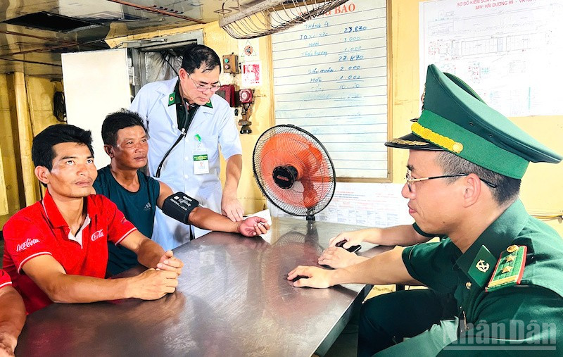 Ban chỉ huy và quân y Biên phòng cửa khẩu cảng Đà Nẵng động viên, thăm khám sức khỏe các ngư dân. (Ảnh: ĐÌNH TĂNG) ndo_br_bp12.jpg