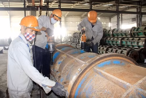 Công nhân Công ty Viết Hải huyện Thạch Hà (Hà Tĩnh) sản xuất cọc bê-tông giá thành hạ, chất lượng tốt. Ảnh: THÀNH CHÂU