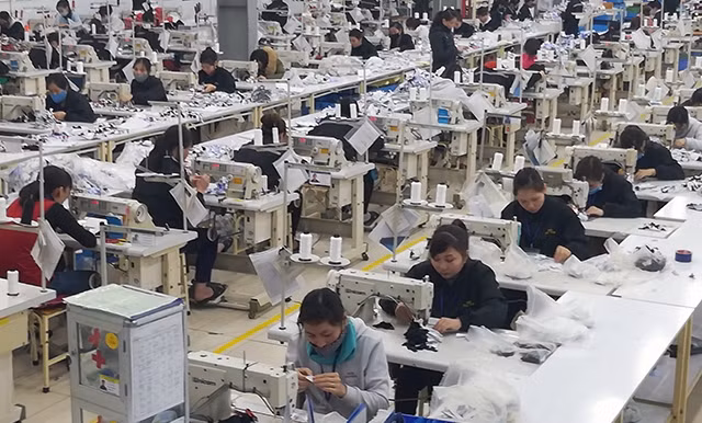 Một góc dây chuyền may chi nhánh Hanosimex ở huyện Nam Ðàn (Nghệ An).